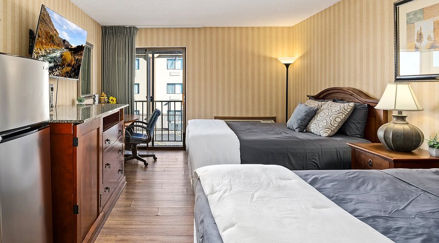 Downtown Extended Stay room interior with two beds and balcony